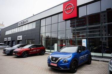 Khmelnytskyi, Ukrayna - 16 Nisan 2025: Nissan arabaları tesisi çevreleyen kentsel binaların bulunduğu bir galerinin önünde sergilendi.