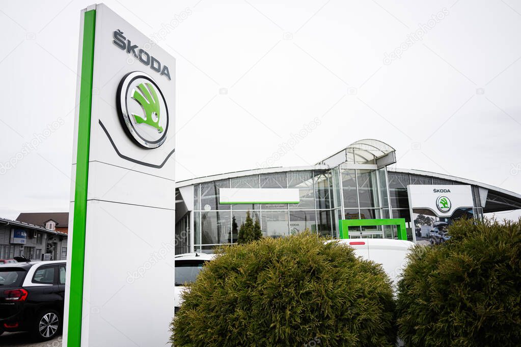 Khmelnytskyi, Ukraine - April 16, 2025: A contemporary car showroom displaying Skoda branding and parked automobiles in the foreground.