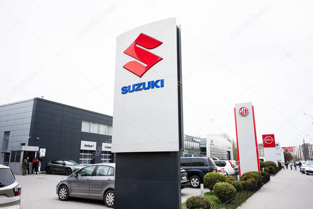 Khmelnytskyi, Ukraine - April 16, 2025: Car dealership exterior with Suzuki, MG, and Nissan signs and parked vehicles