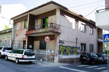 Caldas da Rainha, Portekiz - 17 Nisan 2025: Portekiz 'de eski özelliklere, sokak sanatına ve park edilmiş arabalara sahip bir konut binası.