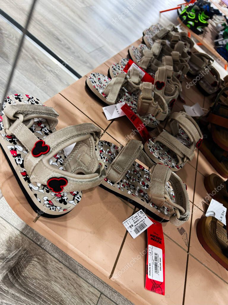 Kyiv, Ukraine - April 23, 2025: Kids sandals featuring a popular Mickey cartoon character printed design, showcased in a store.