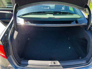 Kyiv, Ukrayna - 28 Nisan 2025: Bir aracın içinde büyük, boş bir siyah kargo alanı olan Audi A4 'ün bagajını açın.