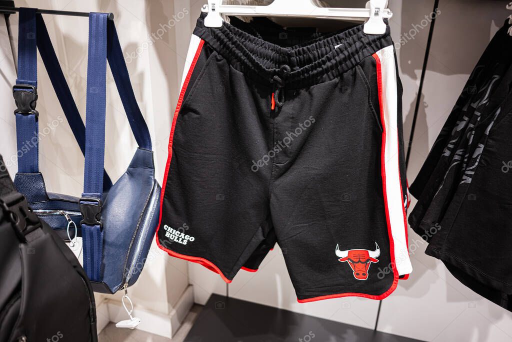 Ivano-Frankivsk, Ukraine - April 29, 2025: Black athletic Chicago Bulls shorts with team logo, hanging with other items in the store.
