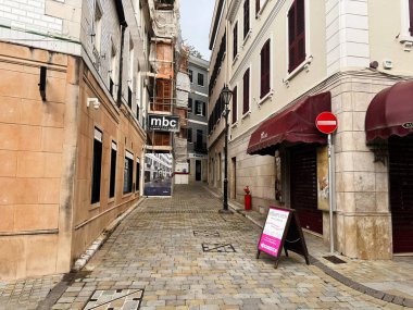 Cebelitarık, İngiltere - 01 Mayıs 2025: Geleneksel binalar ve tabelalarla Cebelitarık 'ta bir kaldırım taşı sokakta yürümek