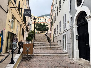 Cebelitarık, İngiltere - 1 Mayıs 2025: Gibraltar 'da yükselen basamaklar, tarihi binalar ve eşsiz şehir cazibesinin yer aldığı sokak.