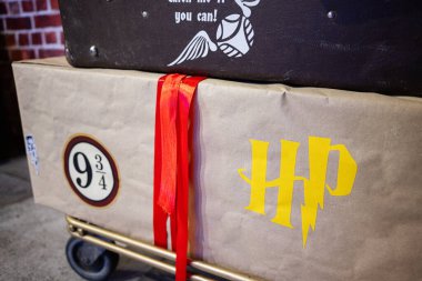 Ivano-Frankivsk, Ukrayna - 29 Nisan 2025: Bir tramvay ve Harry Potter temalı ambalajın yer aldığı büyülü maceralardan esinlenilmiş yaratıcı valizler