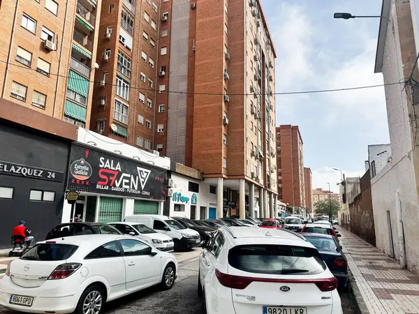 Malaga, İspanya - 02 Mayıs 2025: Malaga İspanya 'da şehir manzarası binaların ve park halindeki arabaların olduğu bir cadde