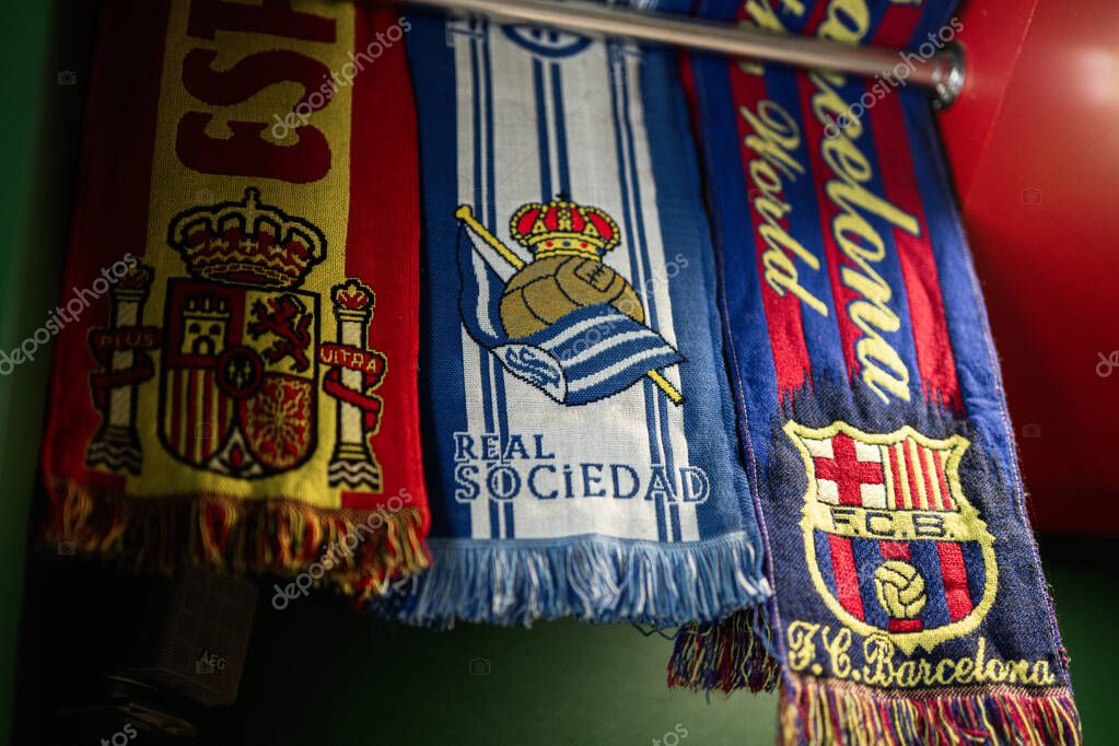 Lviv, Ukraine - May 04, 2025: Scarves featuring football teams and a national emblem arranged with vibrant designs
