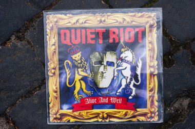 Lviv, Ukrayna - 13 Mayıs 2025: The Quiet Riot Alive and Well albümü 1999 cover with bold Visuals and ortaçağ temaları.