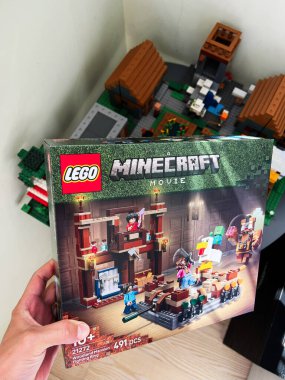 Kyiv, Ukrayna - 14 Mayıs 2025: Bir Minecraft Movie LEGO seti için yakındaki çeşitli LEGO sahnelerinin yer aldığı bir kutu