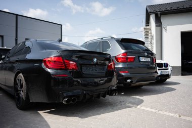 Kyiv, Ukrayna - 10 Haziran 2025: Lüks BMW sedan ve SUV güneşli bir günde açık havada sergilendi.