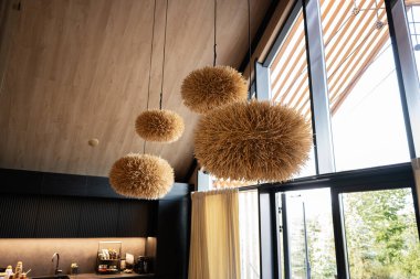 Doğal ve sıcak aksanlı kendine özgü aydınlatma armatürlerinin yer aldığı çağdaş yaşam alanı