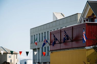 İrlanda ve İzlanda 'nın renkli bayrakları Akranes' teki İrlanda günlerini kutlamak için kırmızı balkonu süslüyor.