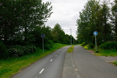 Bisikletler ve yayalar için ayrılmış şeritleri olan sakin bir şehir yolu.