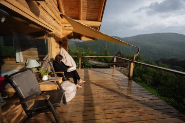 Kamara güvertesindeki açık havada eğlenen bir kadının huzurlu bir sahnesi.