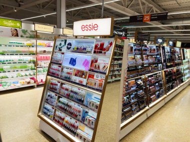 Salford, İngiltere - 25 Eylül 2025: Essie 'nin modern bir Sainsbury süpermarketinde oje ve güzellik ürünlerinin renkli gösterimi.