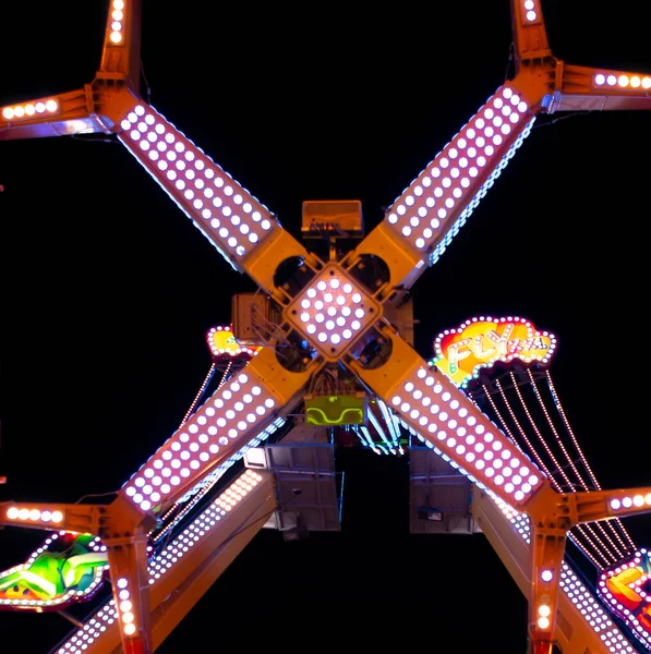 spectacular shot of illuminated fairground ride from below