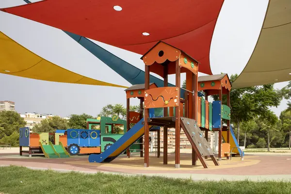 Vibrant children\'s playground under protective shade sails.