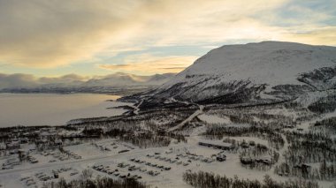 Aerial winter view of Abisko National Park, Kiruna Municipality, Lapland, Norrbotten County, Sweden, shot from drone, with road and mountains. High quality photo clipart