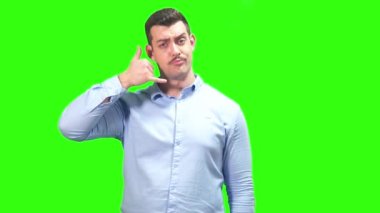 Mavi gömlekli, bıyıklı neşeli adam yeşil ekrana işaret ediyor. Yüksek kalite 4k görüntü
