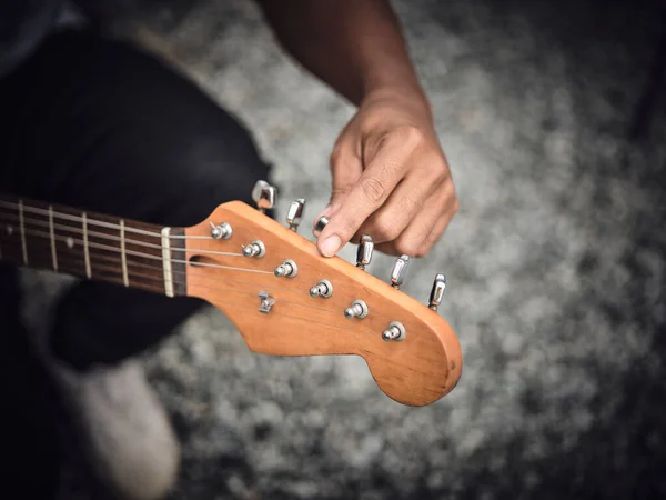 Man Indoors Tuning Guitar Front View Copy Space — Stock Photo, Image