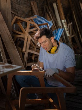 Profesyonel marangoz ahşap atölyesindeki ahşap mobilyaları profesyonel yüksek beceri yapan mobilyalar gibi göstermeye çalışmaktan mutlu. başyapıtlar . 