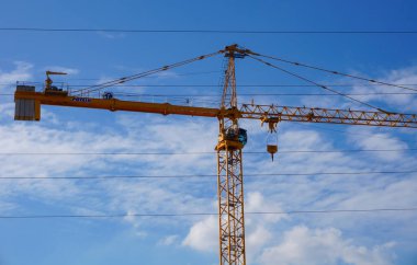 Troyes, France - Sept. 2020 - A yellow construction crane manufactured by Potain, a French branch of the US group Manitowoc and the world leader in tower crane