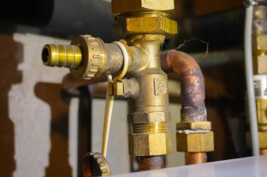 Kasaba gazına bağlı merkezi bir ısıtma sisteminin propan tedariği için bakır ve pirinç musluğun ayrıntıları, bir evin bodrumuna yerleştirilmiş, bakır boru kaynak izleri.