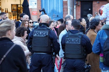 Toulouse, Fransa - Şubat 2023 - Saint-Cyprien Meydanı 'nda emekli aylığı reformunu protesto eden ve taktik yelek giyen üç silahlı polis memurundan oluşan bir grup