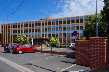 Albi, France - June 2021 - Modern, rectangular building, with a glass facade, of the headquarters of the Family Allowance Office (