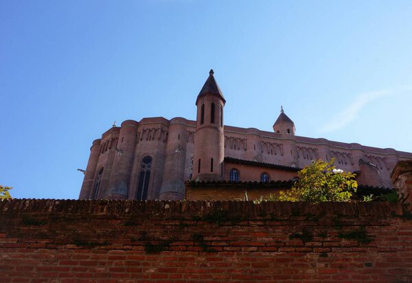 Low angle view of the back (abside) of the brick-built Cathedral of Albi, France, UNESCO World Heritage Site, with auxiliary small bell towers