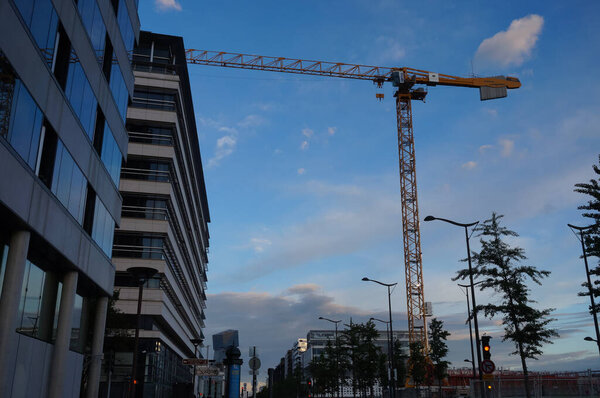 Paris, France - June 2021 - A view in the evening on Avenue de France, one of the main streets of Paris-Rive Gauche business district (13th arrondissement), with a tower crane on a construction site