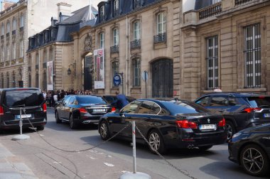 Paris, France - July 2019 - Black luxury cars and official cars (BMW, Mercedes) bringing guests for a social event at Hotel de Charost, seat of the UK Embassy to Paris in Faubourg Saint-Honore clipart