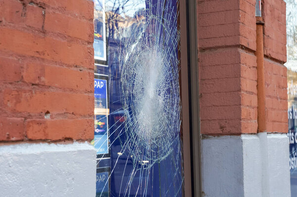 Toulouse, France - April 2023 - Scene of political violence: broken glass on a storefront in the city center, vandalized by far-left fringes amid social unrest over the government's pension reform