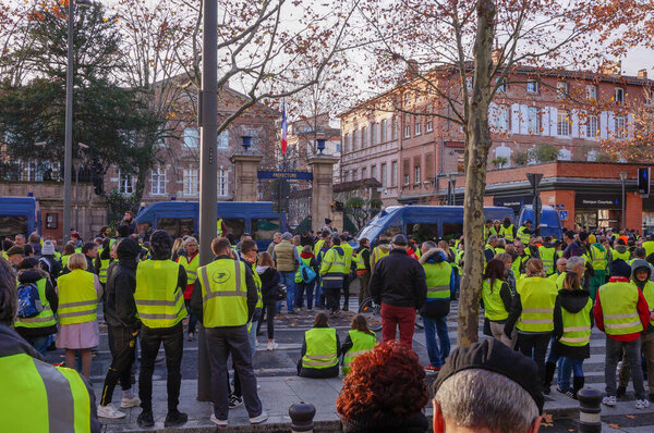 Albi, France - Dec. 2018 - Crowd of Yellow Vest ("Gilets Jaunes") protesters, blocking the main street of Albi during popular protests showing discontent about Emmanuel Macron's policy and government