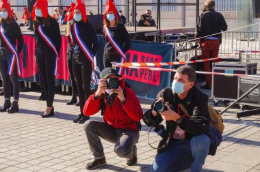 Paris, France - Oct. 10, 2020 - Press photographers crouching to shoot pictures at Marchons Enfants' manifestation in Place Vendme against the French government's bioethics and procreation bill