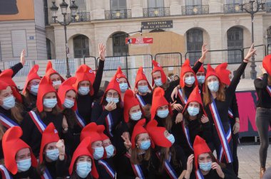 Paris, France - Oct. 10, 2020 - Group of cheerful young female supporters of La Manif pour Tous, dressed up as French 