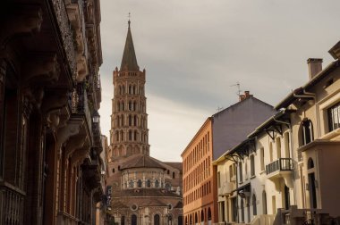 Toulouse, France - Jan. 2020 - The bell tower of the Basilica of Saint-Sernin, a medieval World Heritage Site and the largest romanesque church in Europe, in the perspective of Saint-Bernard Street