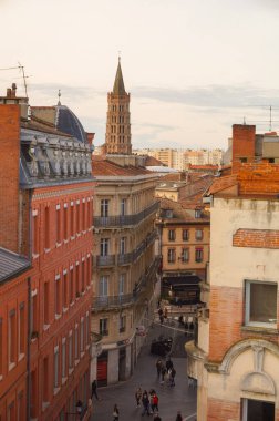 Toulouse, France - Jan. 2020 - The bell tower of the Basilica of Saint-Sernin, a medieval World Heritage Site and the largest romanesque church in Europe, in the perspective of Saint-Bernard Street