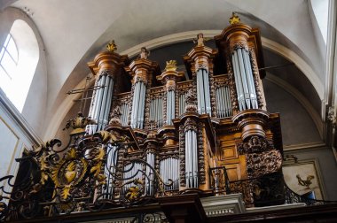 Toulouse, France - March 2020 - Imposing loft organ on the grandstand of the baroque church of Saint-Pierre des Chartreux (Saint Peter of the Carthusian monastery), featuring richly carved wood