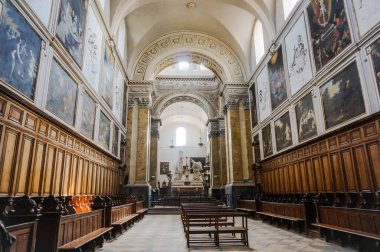Toulouse, France - March 2020 - Paintings, benches and grandstand organ in the wooden choir stalls inside the baroque church of Saint-Pierre des Chartreux (Saint Peter of the Carthusian monastery