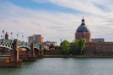 Low angle view of 19th century Saint Joseph de La Grave's Chapel; this terracotta brick church located in Saint-Cyprien, in Toulouse, France, features a copper dome topped with a roof lantern