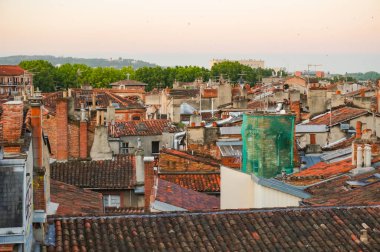 Toulouse, France - Feb. 2020 - Typical brick southern townhouses seen from the multi-storey car park in Place des Carmes, in the most expensive neighborhood of Toulouse, featuring old wooden shutters