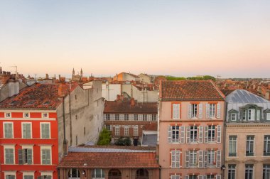 Elevated view over ancient, Southern-style town buildings, constructed in traditional brick on Rue Pharaon Street, in the historic neighborhood of Carmes, in the city center of Toulouse, France