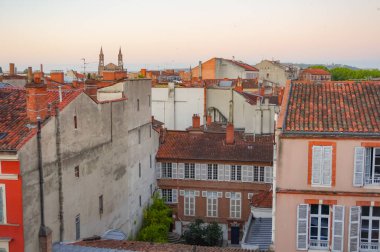 Elevated view over ancient, Southern-style town buildings, constructed in traditional brick on Rue Pharaon Street, in the historic neighborhood of Carmes, in the city center of Toulouse, France
