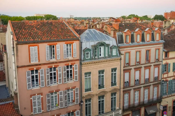 Elevated view over ancient, Southern-style town buildings, constructed in traditional brick on Rue Pharaon Street, in the historic neighborhood of Carmes, in the city center of Toulouse, France
