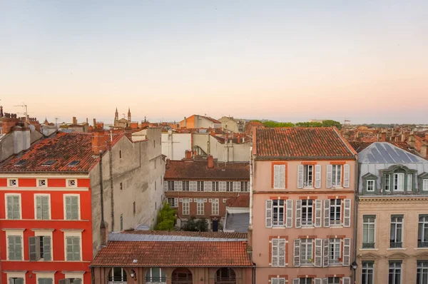 Elevated view over ancient, Southern-style town buildings, constructed in traditional brick on Rue Pharaon Street, in the historic neighborhood of Carmes, in the city center of Toulouse, France