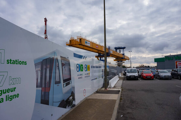 Labge, France - Dec. 2, 2023 - Girder launcher for the building of the viaduct for the extension of Toulouse's metro Line B; on the construction barrier, an information board presents the project