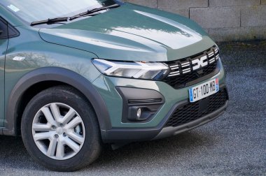 Aveyron, France - March 10, 2024 - Detail of the front of a brand-new Dacia Jogger; the front is shared with the Sandera, another model from Dacia, Romanian branch of French car manufacturer Renault clipart