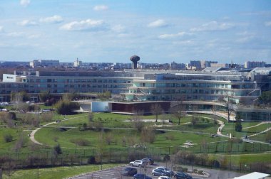 Toulouse, France - March 15, 2024 - Modern architecture of the cutting-edge IUCT Hospital on Oncopole Campus, dedicated to cancer research; it has curved glass facades and a vast landscaped park clipart